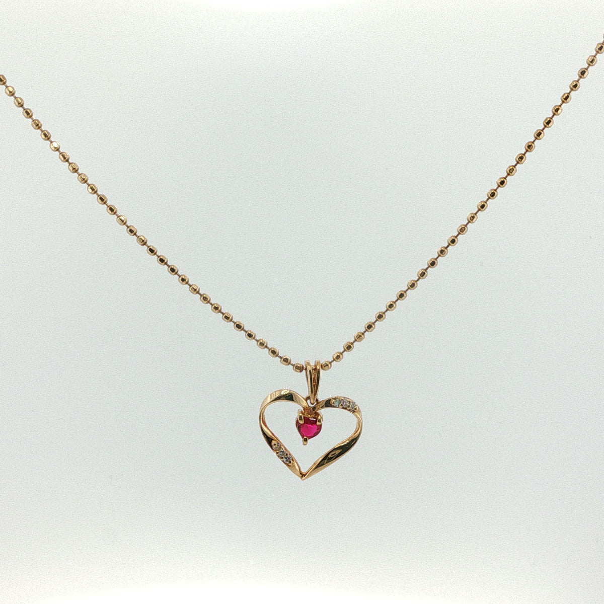 Open Heart Ruby Charm Necklace in Yellow Gold
