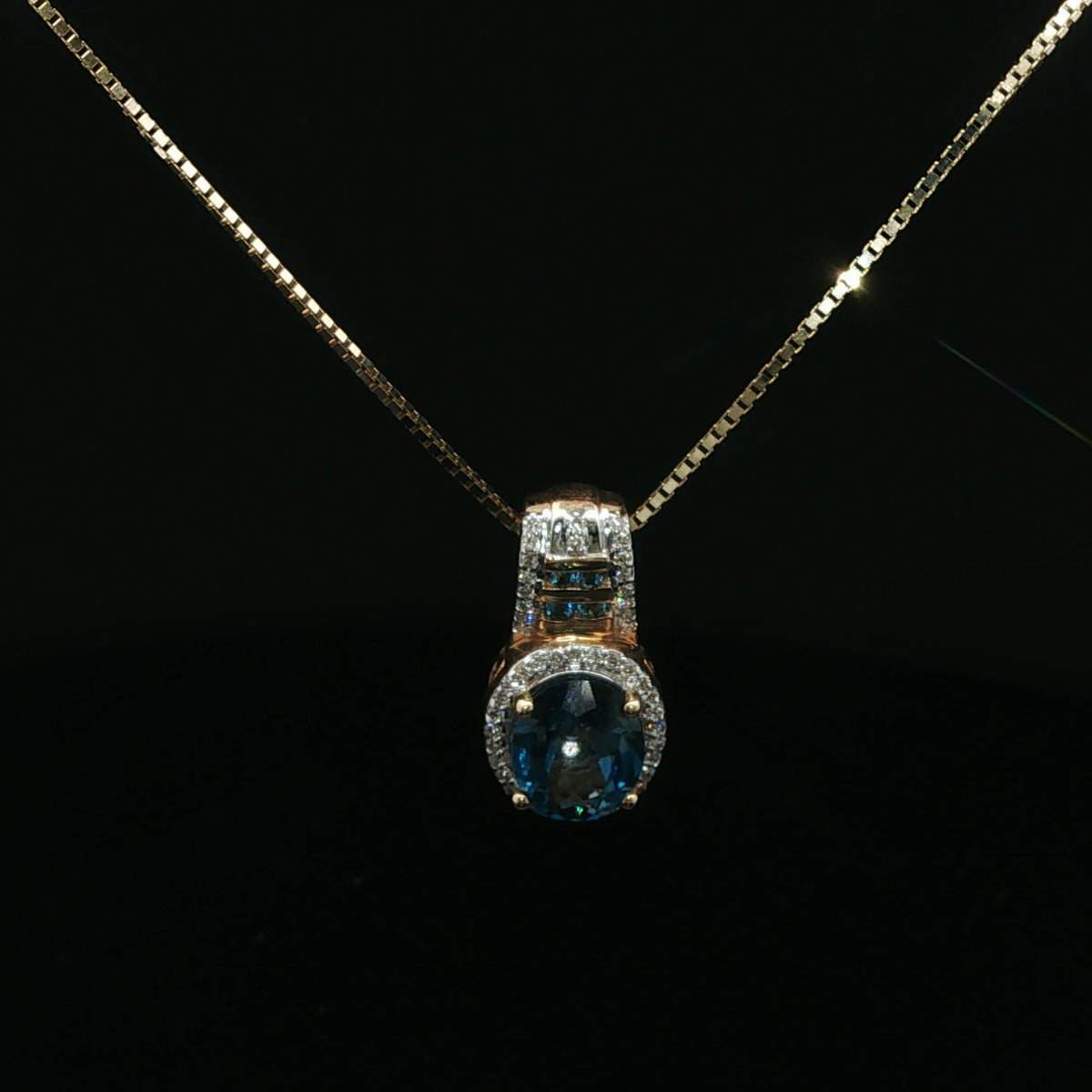 Oval Blue Topaz Halo Pendant Necklace in Yellow Gold