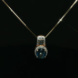 Oval Blue Topaz Halo Pendant Necklace in Yellow Gold