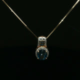 Oval Blue Topaz Halo Pendant Necklace in Yellow Gold