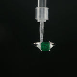 Emerald and Trillion Diamond Three-Stone Ring in White Gold